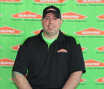 image of male employee standing in front of SERVPRO backdrop