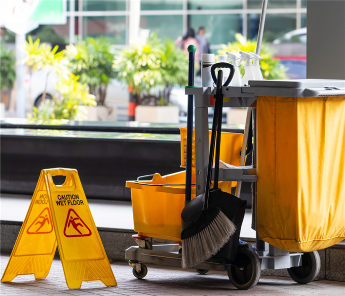 janitor cleaning cart and wet floor sign